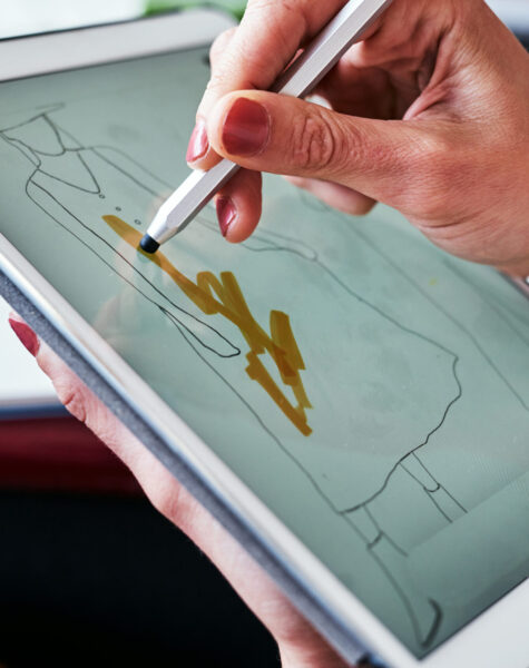 Modern technology makes life a whole lot easier. a fashion designer using a digital tablet to create new designs. Modern technology makes life a whole lot easier. a fashion designer using a digital tablet to create new designs