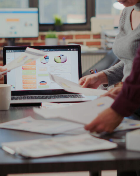 Business people looking at project reports on files Business people looking at project reports on files to plan successful presentation with financial charts and results. Man and women working together to help with company growth. Close up