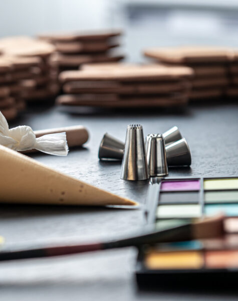 Pastry bags with cream for decorating gingerbread. Palette of food paint for baking and gingerbread.