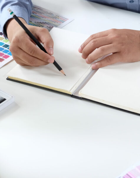 Graphic designer working with drawing tablet and colour swatches Graphic designer working with drawing tablet and colour swatches