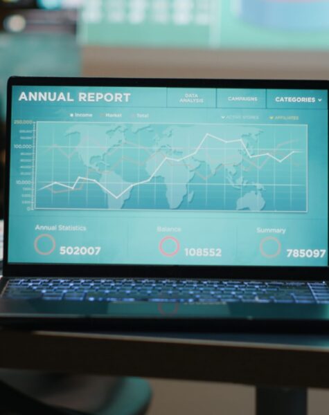 Close up of laptop running data insights in empty dark office late at night, forecasting financial situation and ensuring objectives accomplishment with indicators. Boardroom reporting.